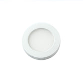 A circular white downlight with a sleek white plastic cover, ideal for contemporary interior lighting.